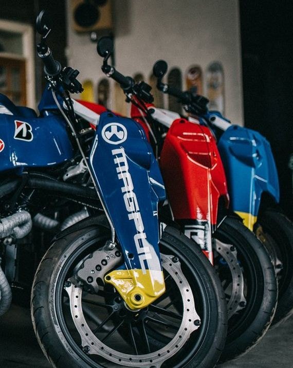 Three Ronin motorcycles in replica race paint in a workshop
